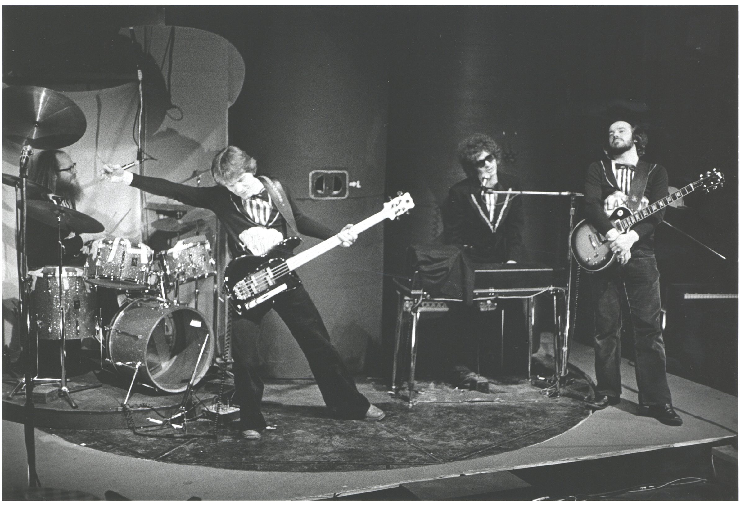 A black and white photo of a band playing music.